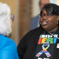 two women chat at celebration event
